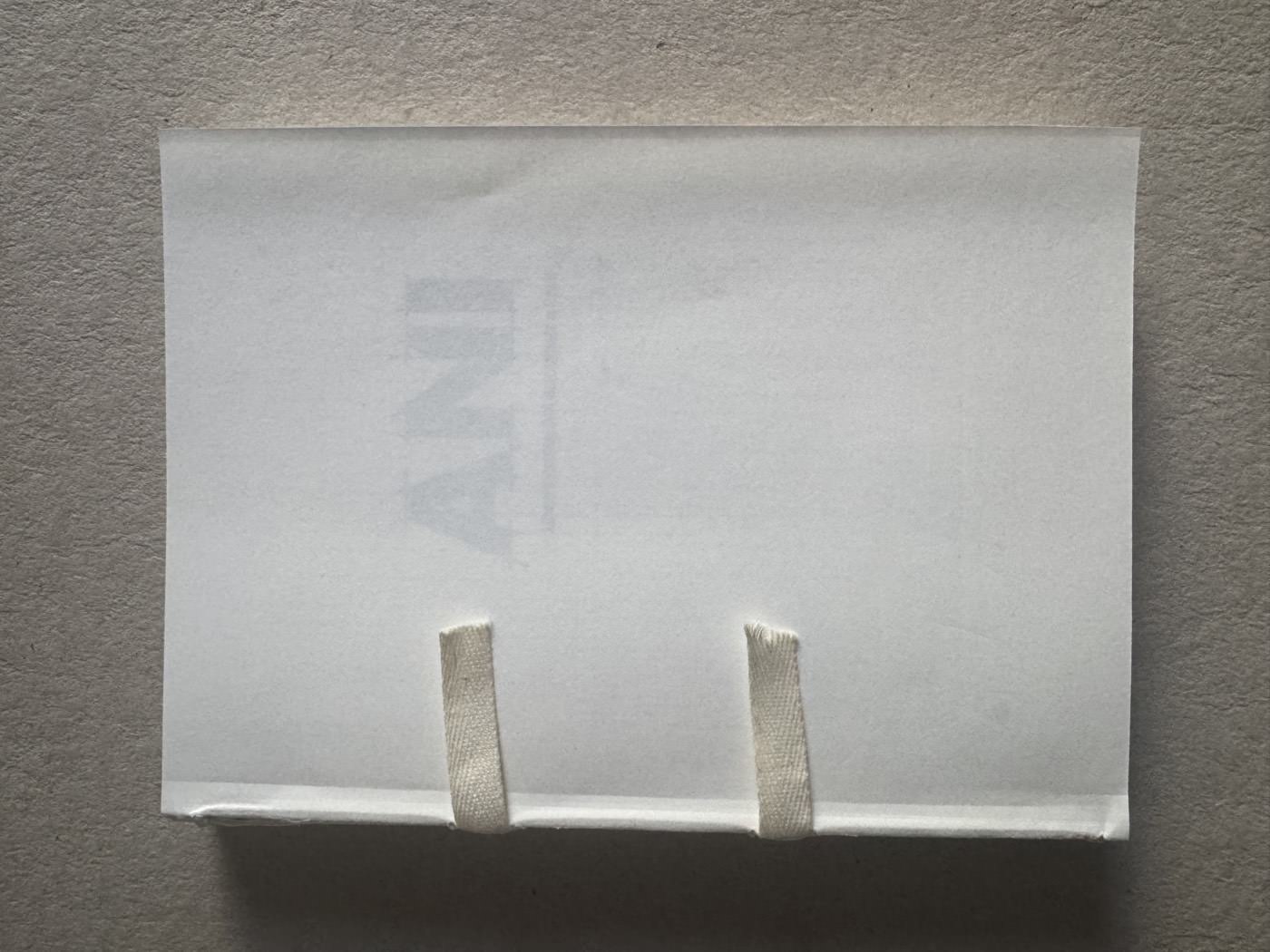 A trial binding, cover lettering visible beneath the paper