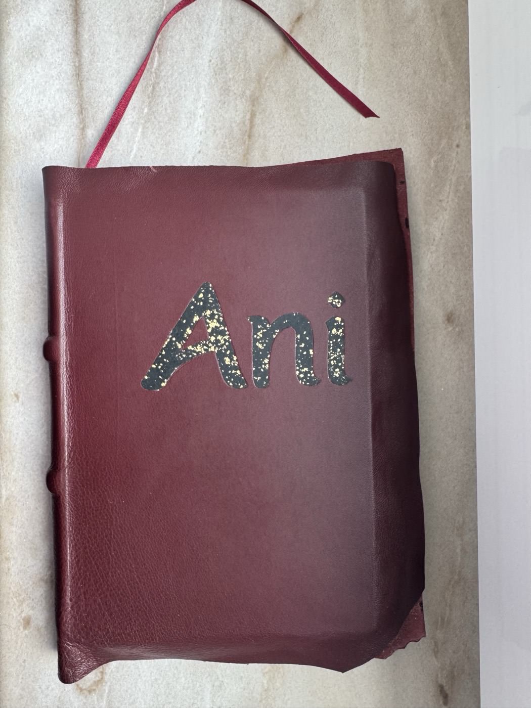 The finished leather cover with its title and ribbon